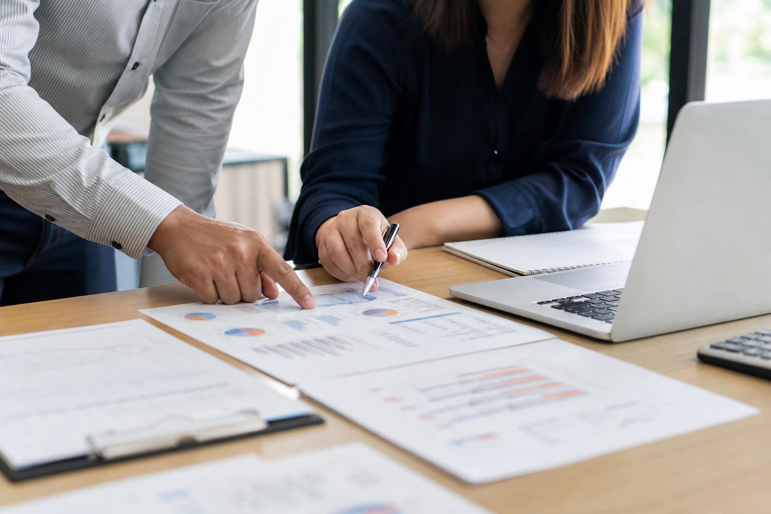 A business owner reviewing website and campaign results with a specialist